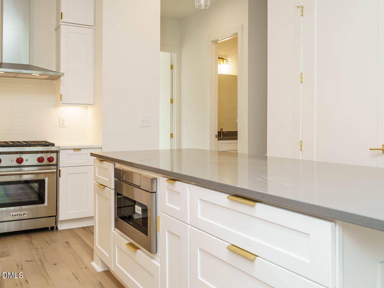 1533 Urban Trace Lane Raleigh, NC 27608 - Photo 16 of 28 a kitchen with granite countertop white cabinets and white appliances