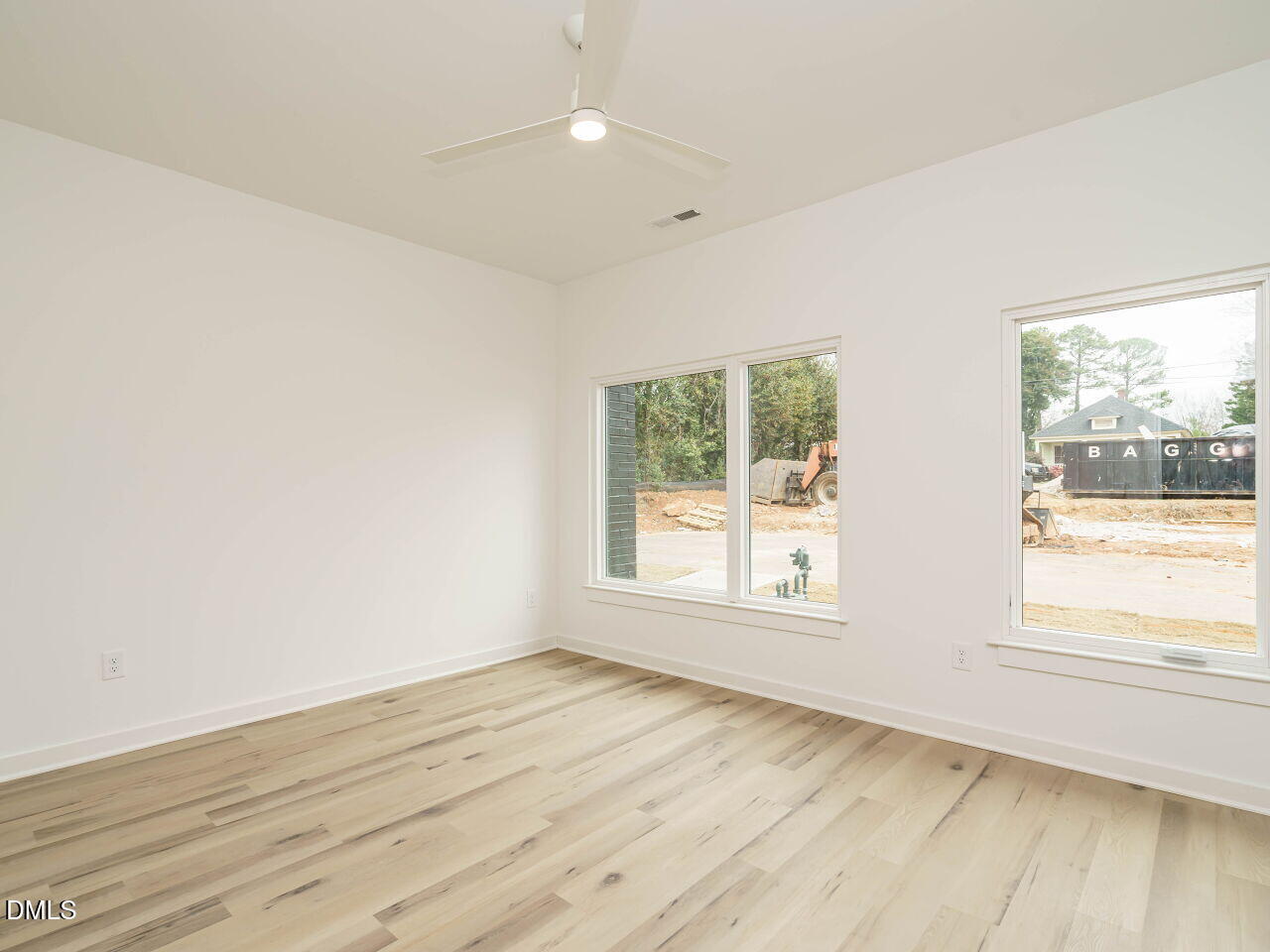 1533 Urban Trace Lane Raleigh, NC 27608 - Photo 6 of 28 an empty room with wooden floor and windows