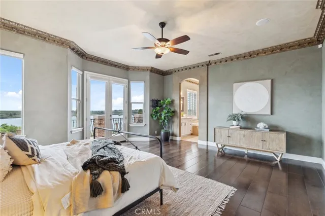 a view of a balcony with wooden floor and iron fence