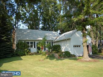 a front view of a house with a yard garage and outdoor seating