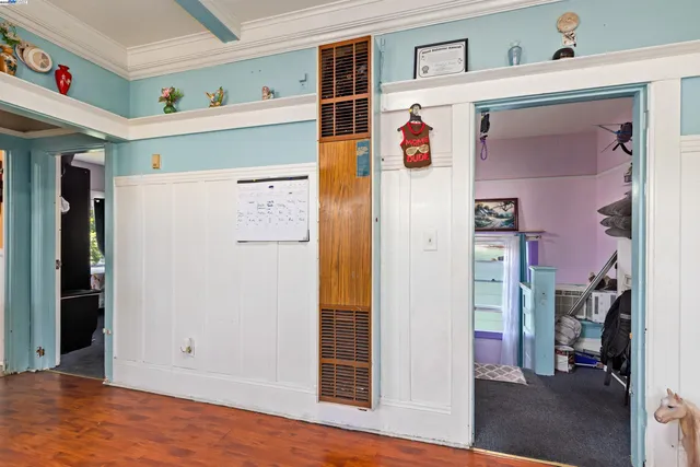 a bedroom with bed and wooden floor