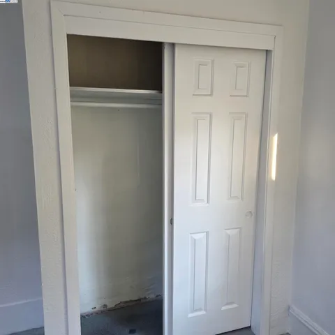 a balcony with wooden floor and outdoor seating