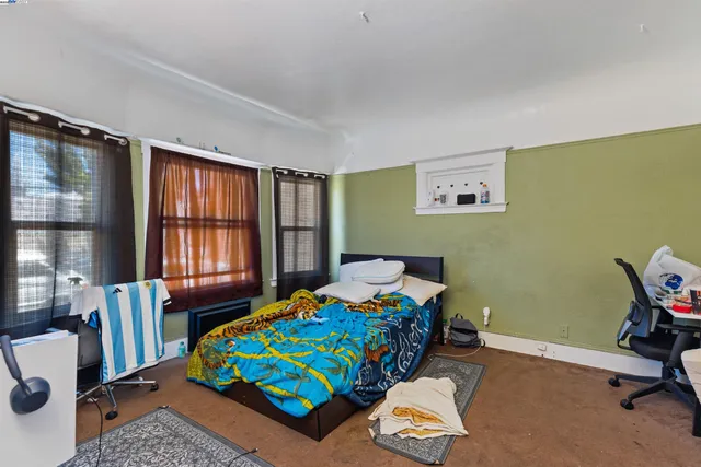 a bedroom with a bed and windows