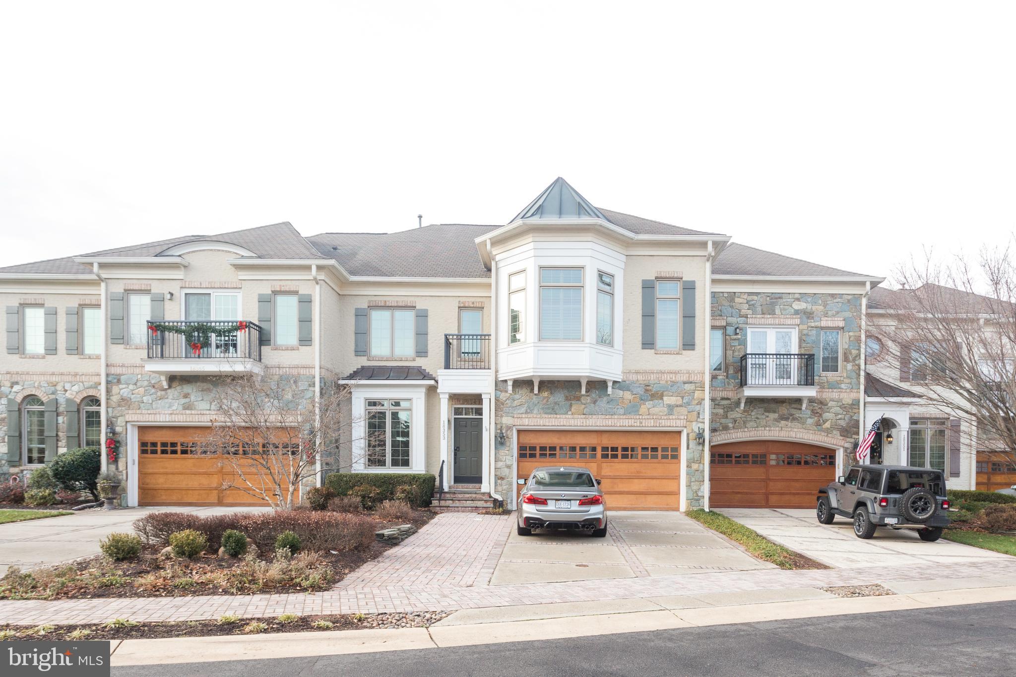 a front view of a building with lot of cars parked