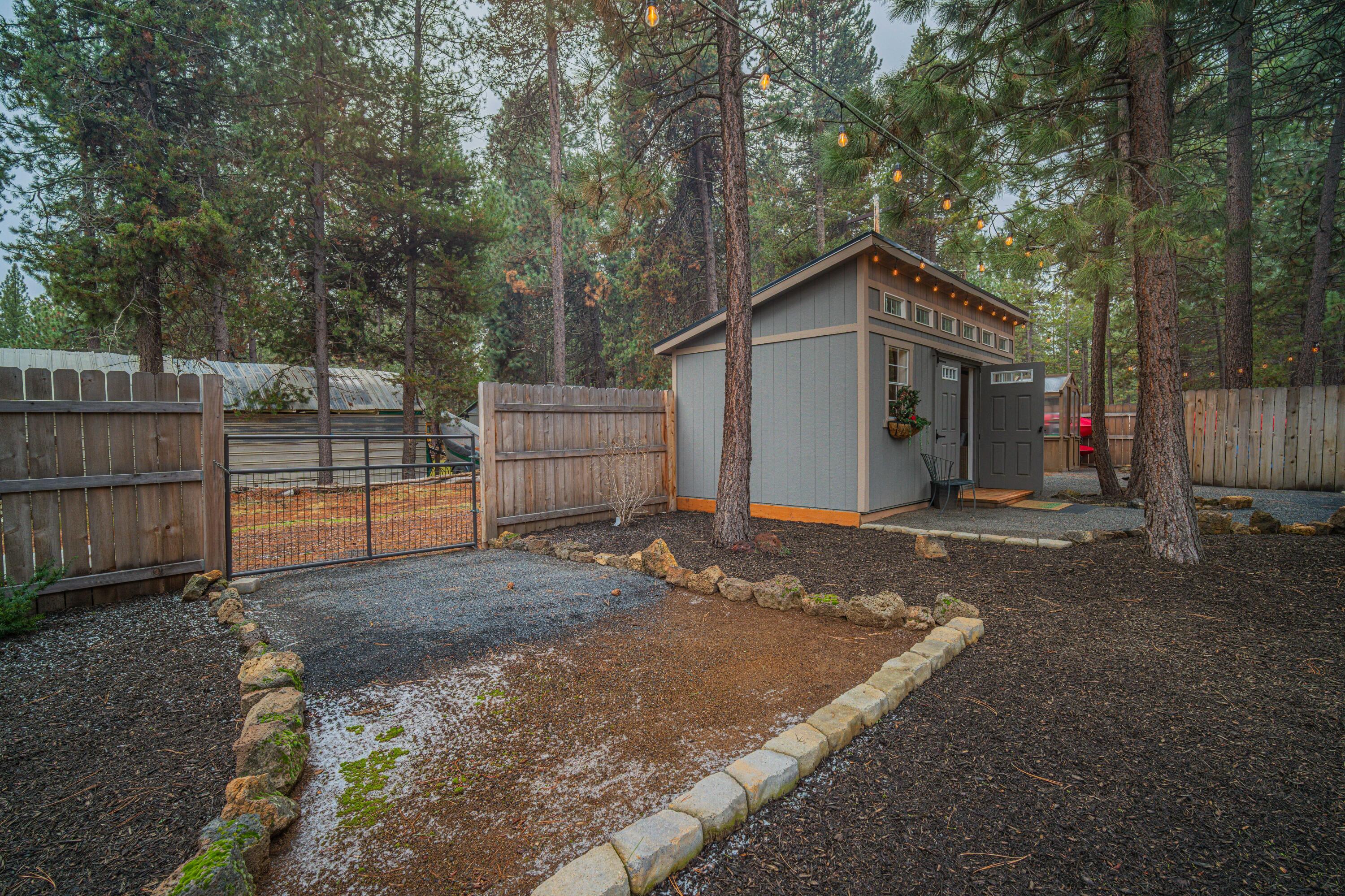 16927 Covina Road Bend, OR 97707 - Photo 47 of 54 Exterior view of the finished backyard outbuilding, a charming and useful bonus structure that enhances the flexibility and appeal of the property.