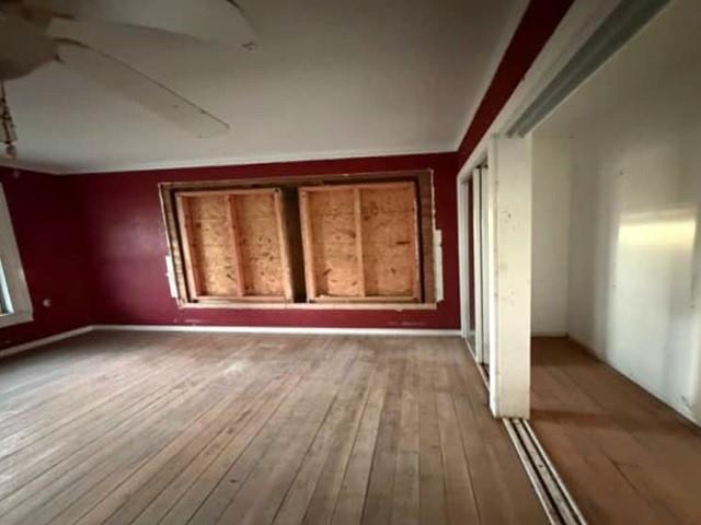 6098 Highway 2 Sarepta, LA 71071 - Photo 5 of 8 an empty room with wooden floor and windows