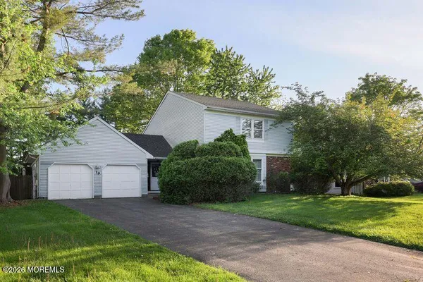 a front view of house with a yard and trees