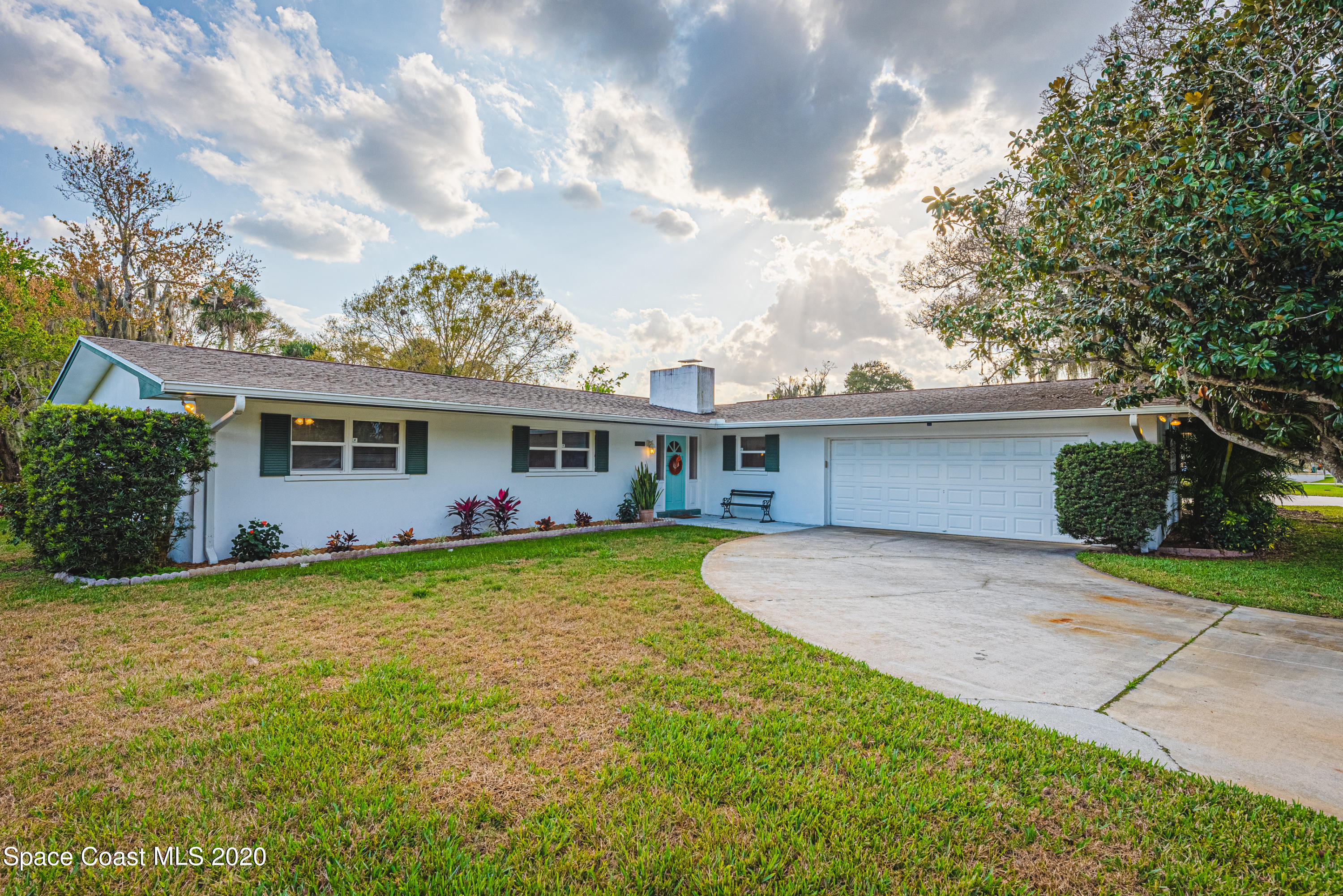 1945 Trimble Road Melbourne, FL 32934 - Photo 2 of 83 a front view of a house with a garden