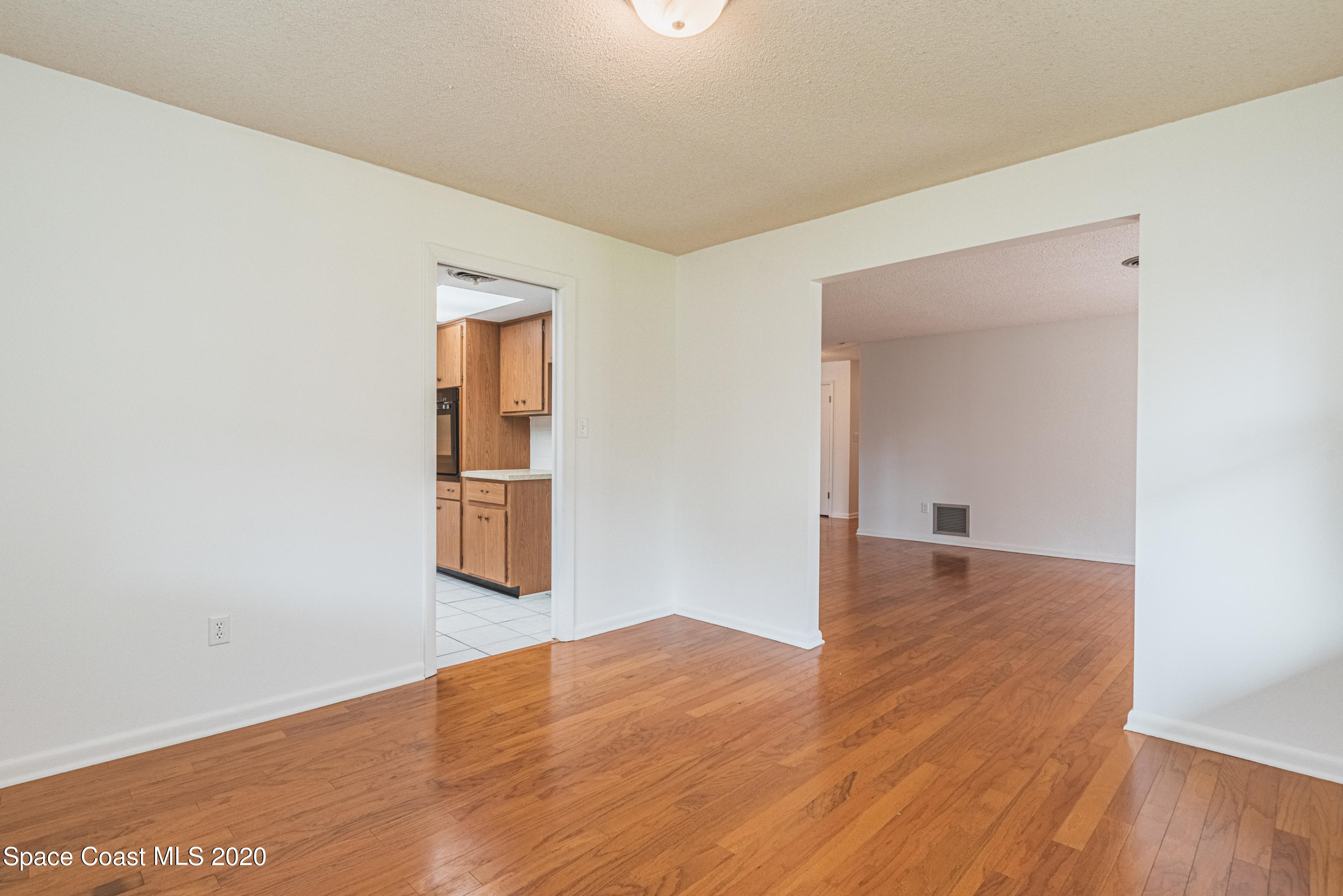 1945 Trimble Road Melbourne, FL 32934 - Photo 17 of 83 an empty room with wooden floor and closet
