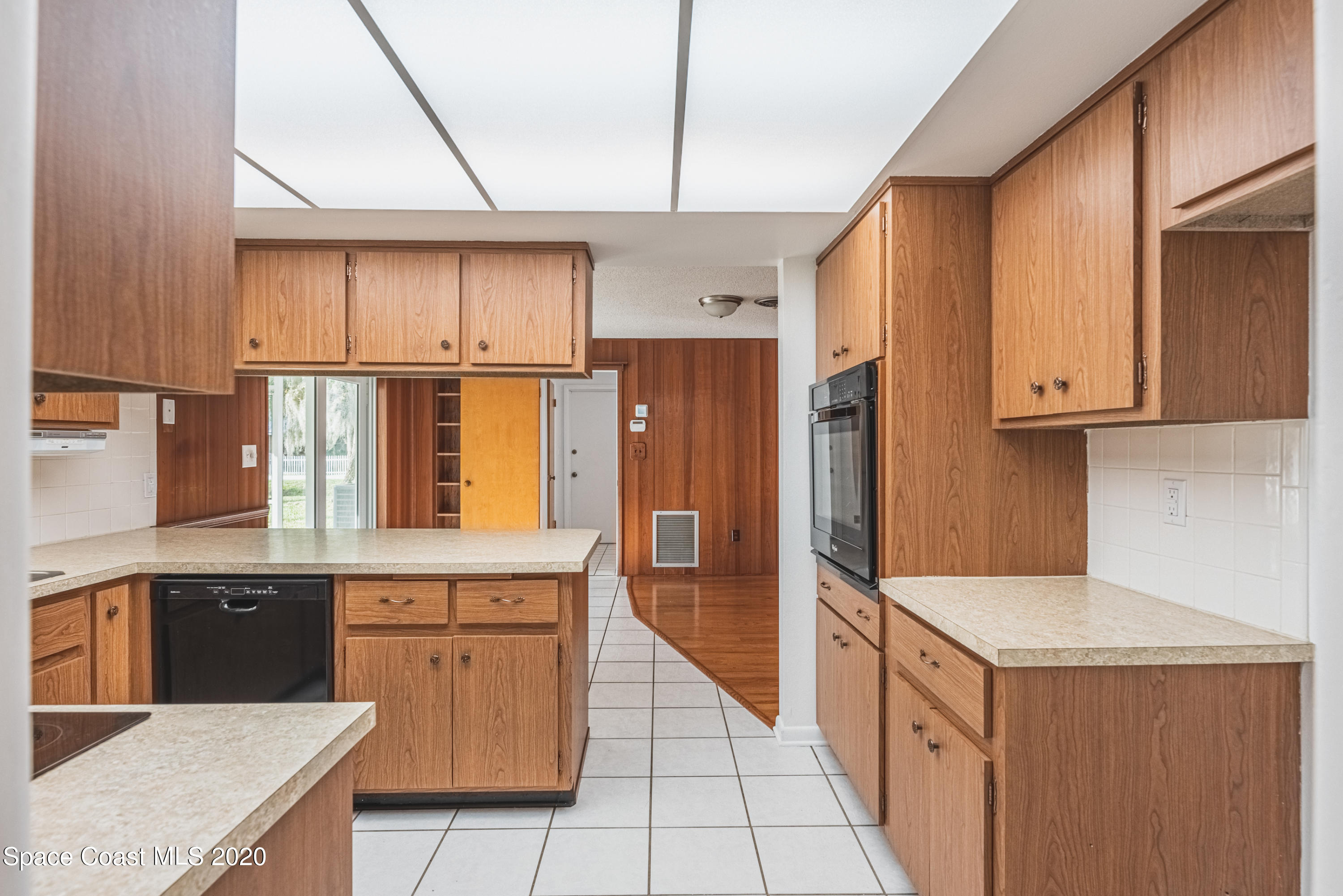 1945 Trimble Road Melbourne, FL 32934 - Photo 21 of 83 a kitchen with stainless steel appliances granite countertop a refrigerator a stove and a sink with wooden cabinets