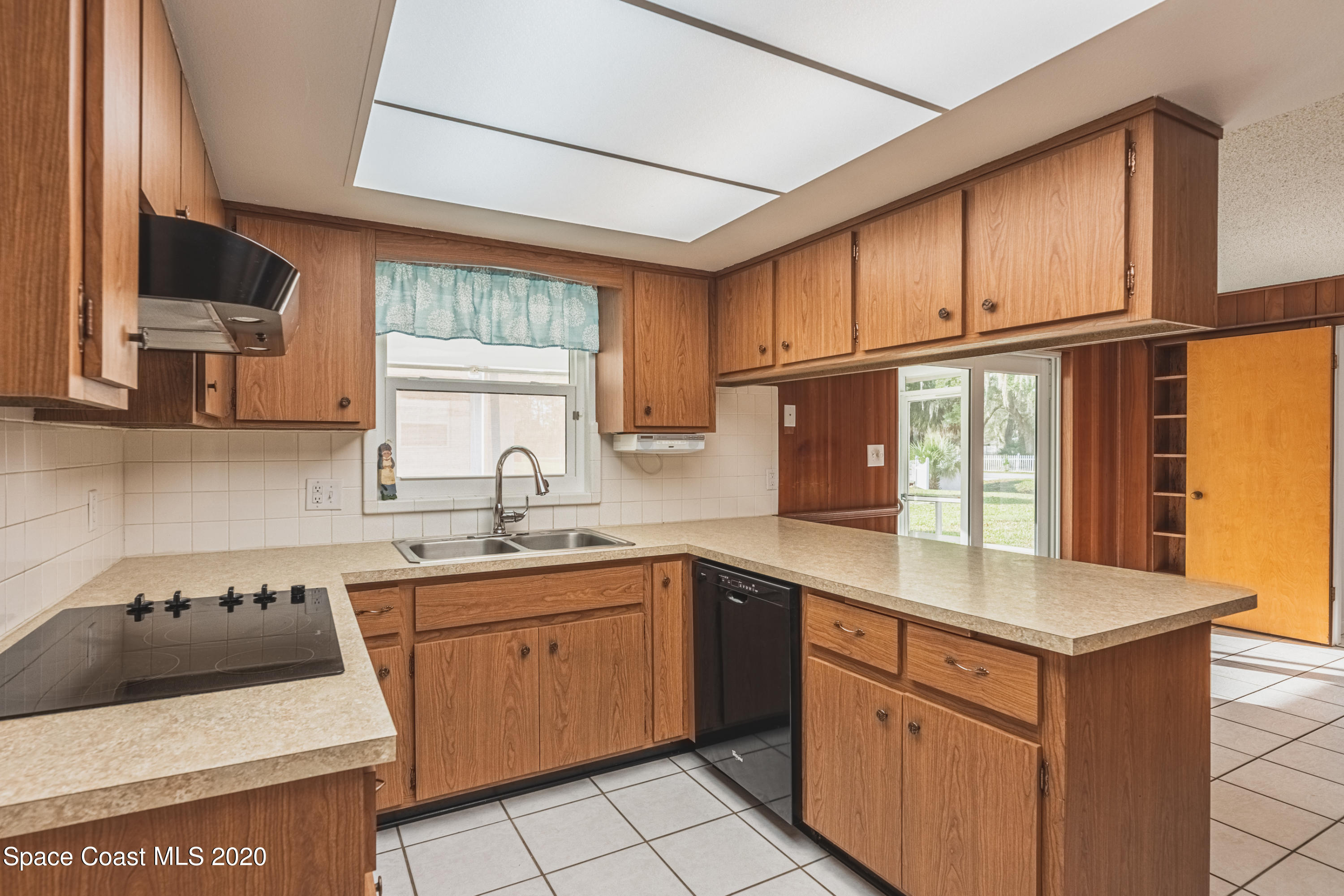1945 Trimble Road Melbourne, FL 32934 - Photo 22 of 83 a kitchen with a sink stove and cabinets