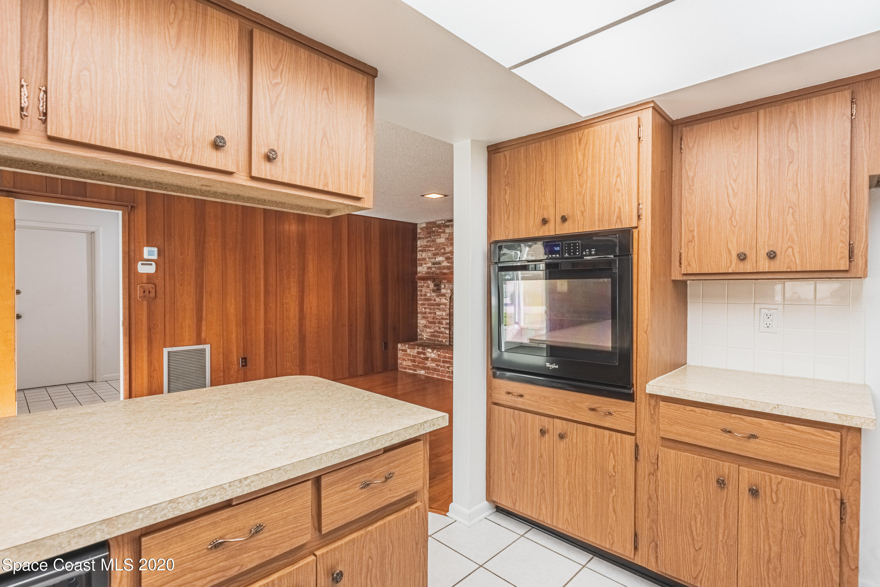 1945 Trimble Road Melbourne, FL 32934 - Photo 23 of 83 a kitchen with granite countertop cabinets stainless steel appliances and wooden cabinets