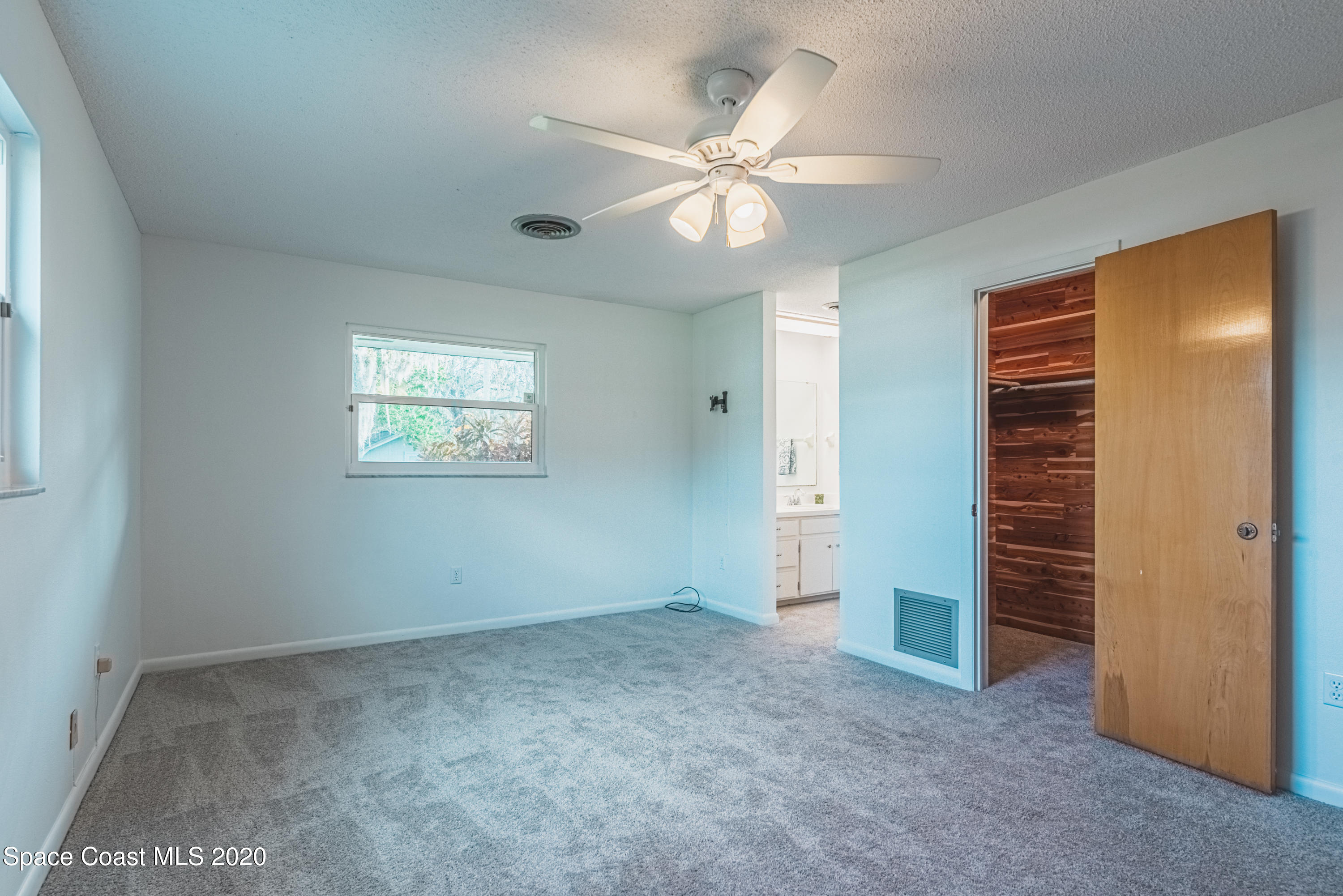 1945 Trimble Road Melbourne, FL 32934 - Photo 39 of 83 an empty room with closet and fan