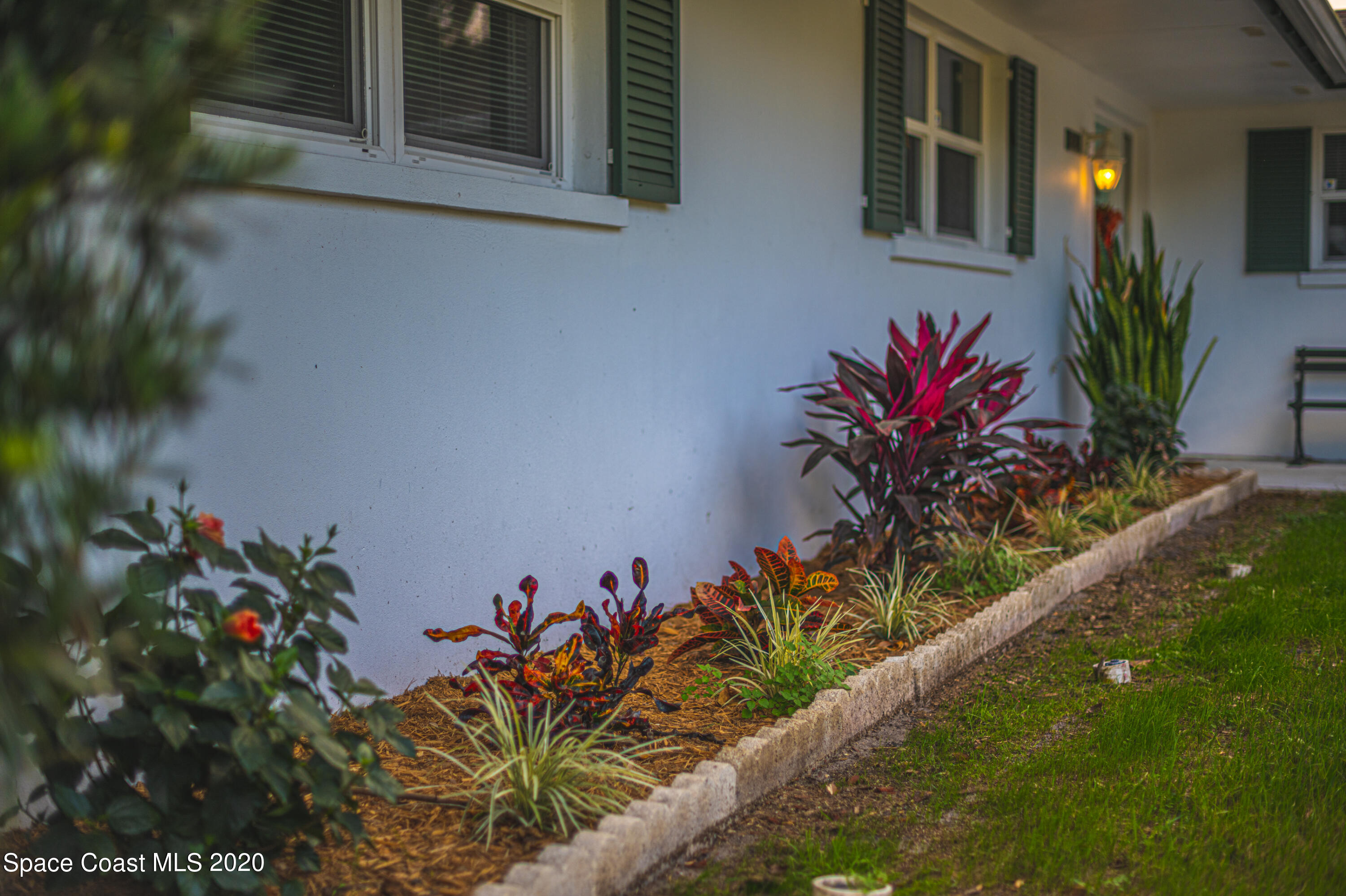 1945 Trimble Road Melbourne, FL 32934 - Photo 5 of 83 a vase of flowers sitting on a floor in front of a house