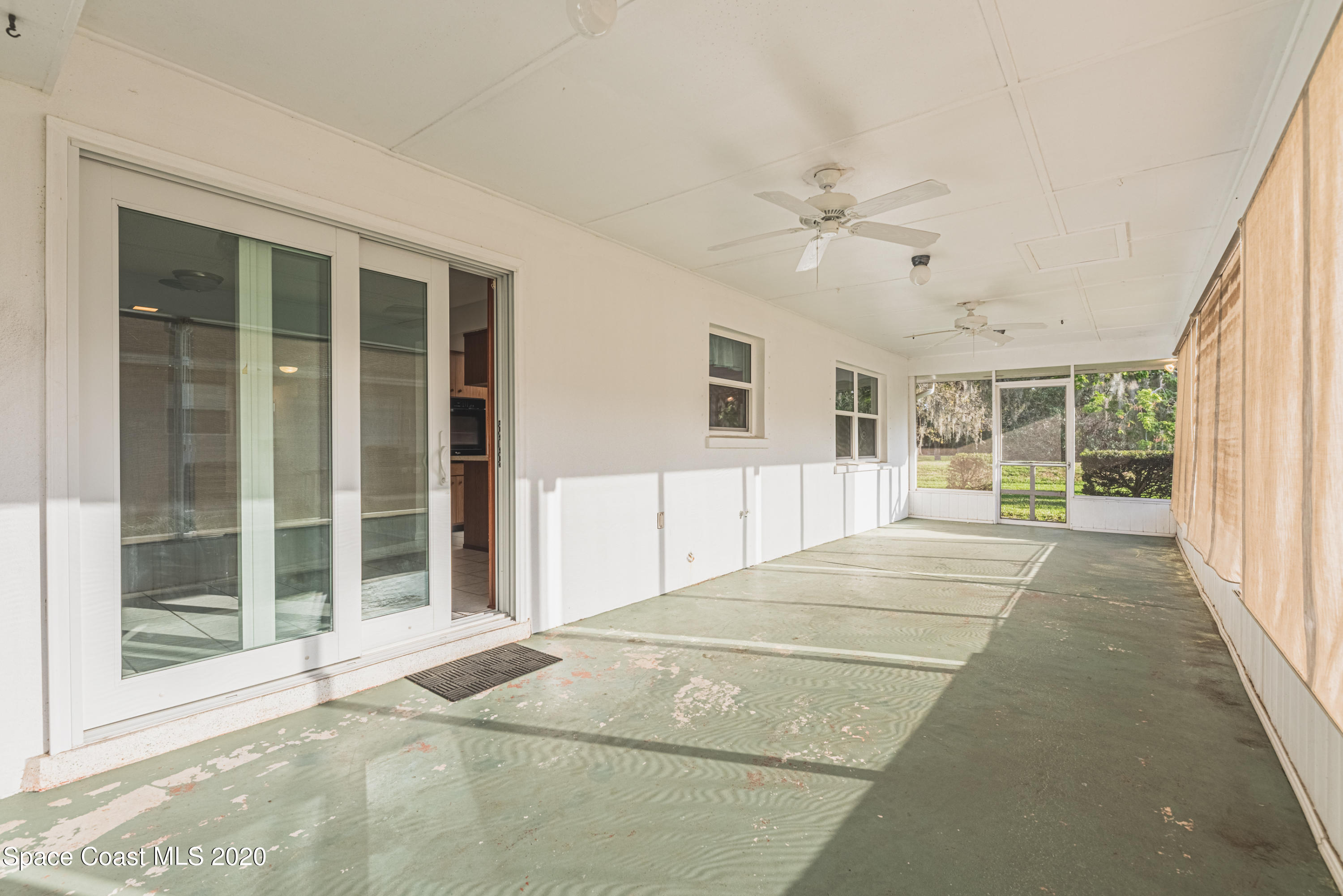 1945 Trimble Road Melbourne, FL 32934 - Photo 46 of 83 a view of an empty room with a window and balcony