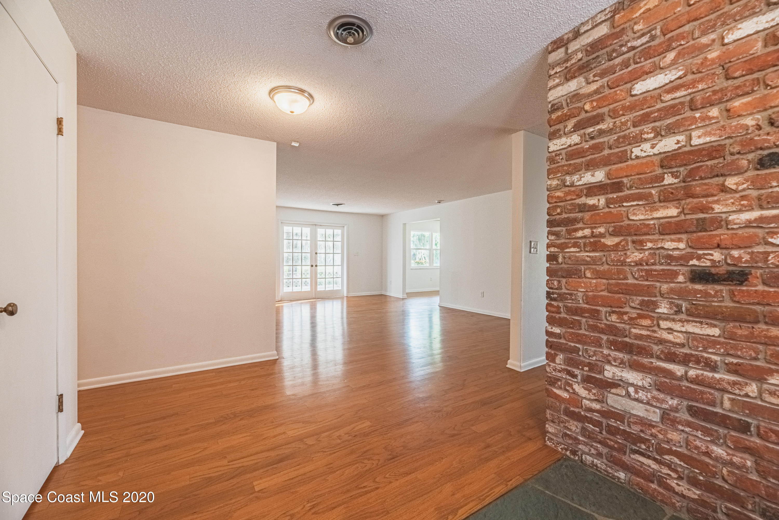 1945 Trimble Road Melbourne, FL 32934 - Photo 57 of 83 a view of an empty room with wooden floor and a window