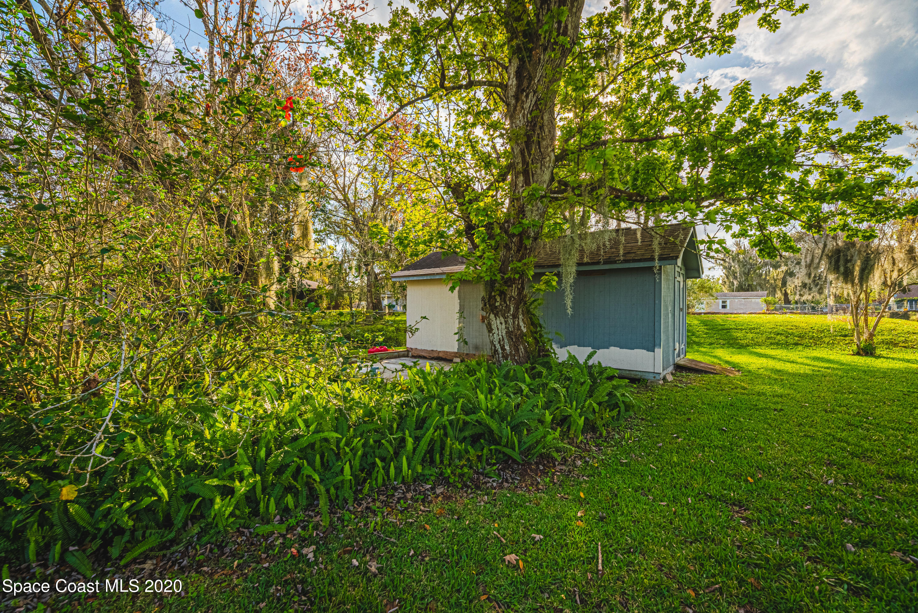1945 Trimble Road Melbourne, FL 32934 - Photo 62 of 83 a view of a house with a tree