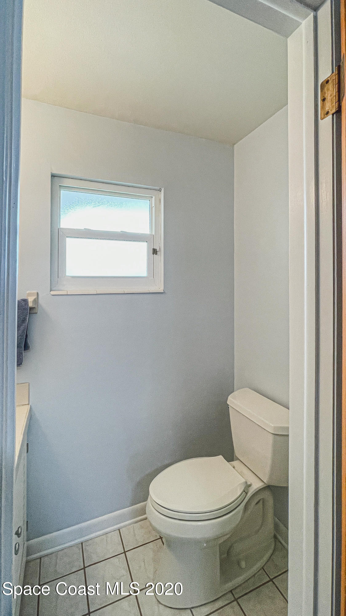 1945 Trimble Road Melbourne, FL 32934 - Photo 72 of 83 a white toilet sitting next to a window