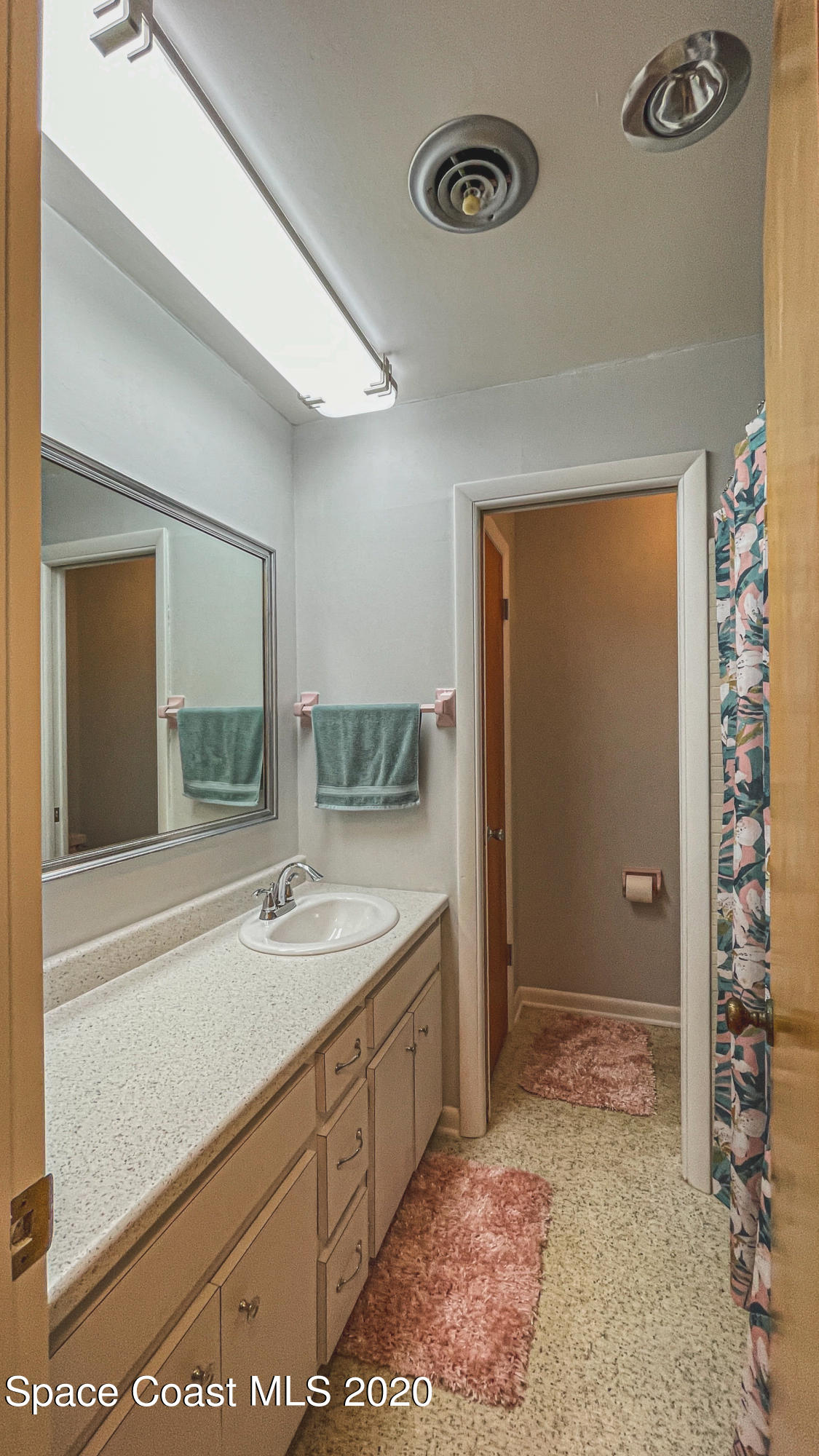 1945 Trimble Road Melbourne, FL 32934 - Photo 74 of 83 a spacious bathroom with a sink and a mirror
