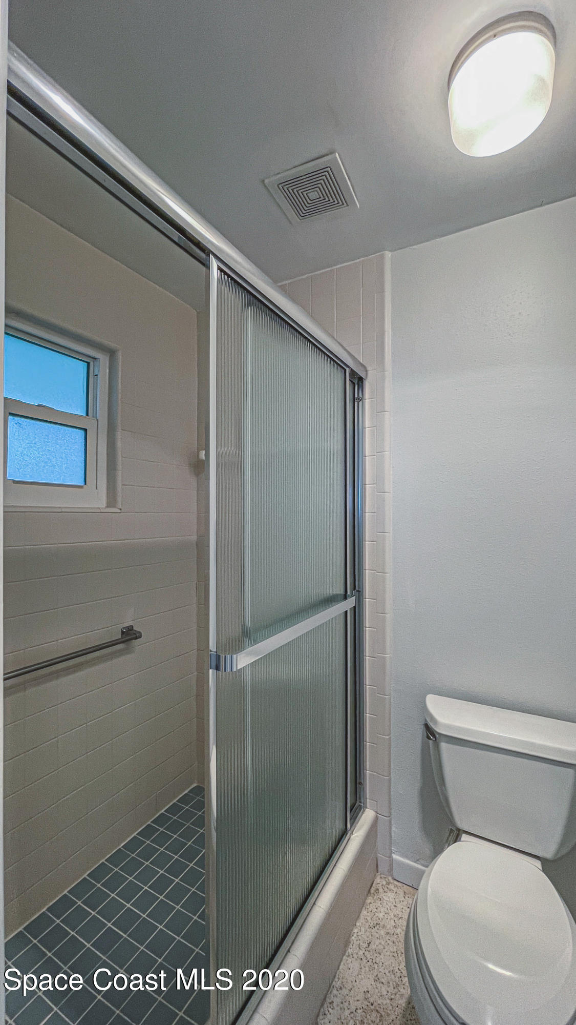 1945 Trimble Road Melbourne, FL 32934 - Photo 79 of 83 a bathroom with a toilet and a shower