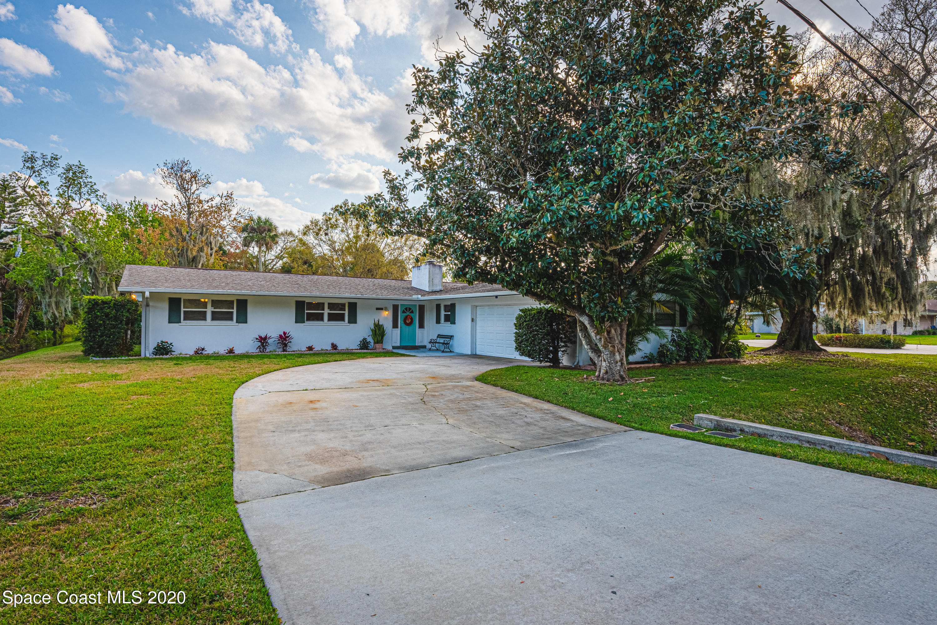 1945 Trimble Road Melbourne, FL 32934 - Photo 80 of 83 a front view of house with yard and trees