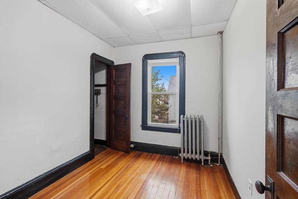 43 Elmdale Street, Unit 2 West Springfield, MA 01089 - Photo 7 of 14 an empty room with wooden floor and windows