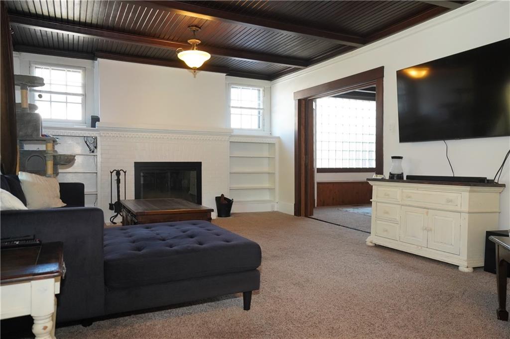 124 Hazel Street Kittanning, PA 16201 - Photo 8 of 26 a living room with furniture a flat screen tv and a fireplace