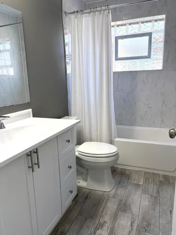 a bathroom with a toilet a sink and a bathtub