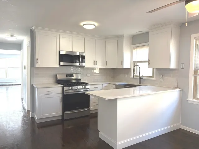 a kitchen with a stove a sink and a refrigerator