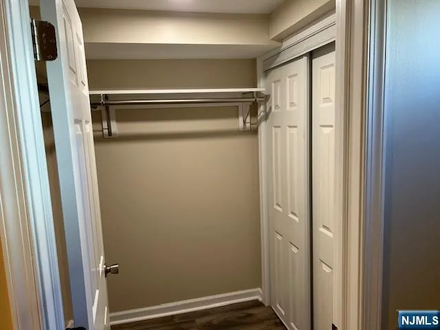 a view of hallway with wooden floor