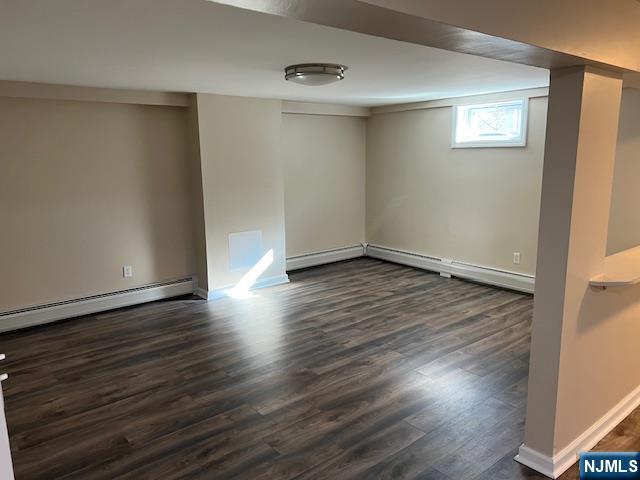 43 Frederick Street, Unit BSMT Garfield, NJ 07026 - Photo 8 of 18 an empty room with wooden floor and windows