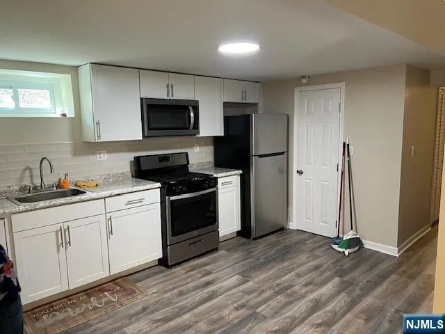 a view of a room with wooden floor
