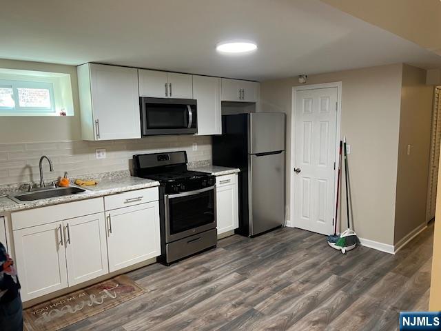 43 Frederick Street, Unit BSMT Garfield, NJ 07026 - Photo 10 of 18 a kitchen with a sink a refrigerator and a stove top oven