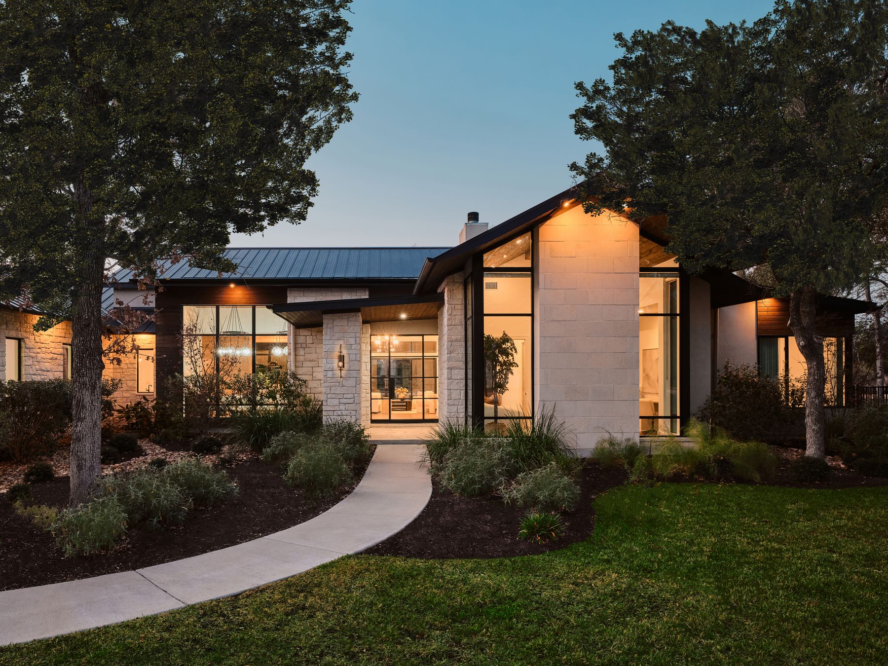 Contemporary house featuring a front lawn and a metal roof