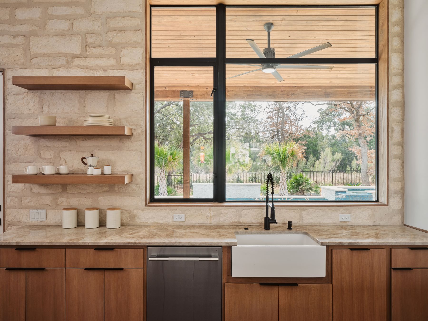 183 Tiffanie Way Austin, TX 78737 - Photo 13 of 37 Kitchen with light stone counters, dishwasher, modern cabinets, wood finish cabinets, and a ceiling fan