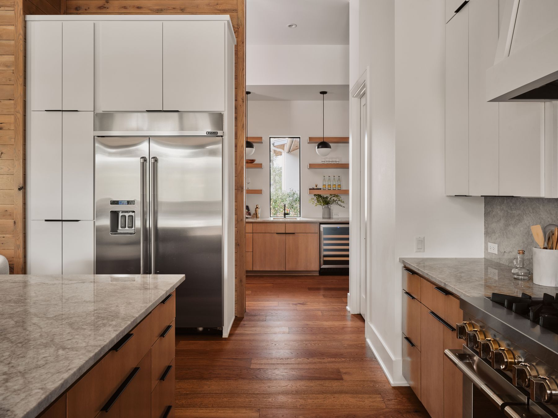 183 Tiffanie Way Austin, TX 78737 - Photo 14 of 37 Kitchen with light stone countertops, high end appliances, dark wood-type flooring, exhaust hood, and wine cooler