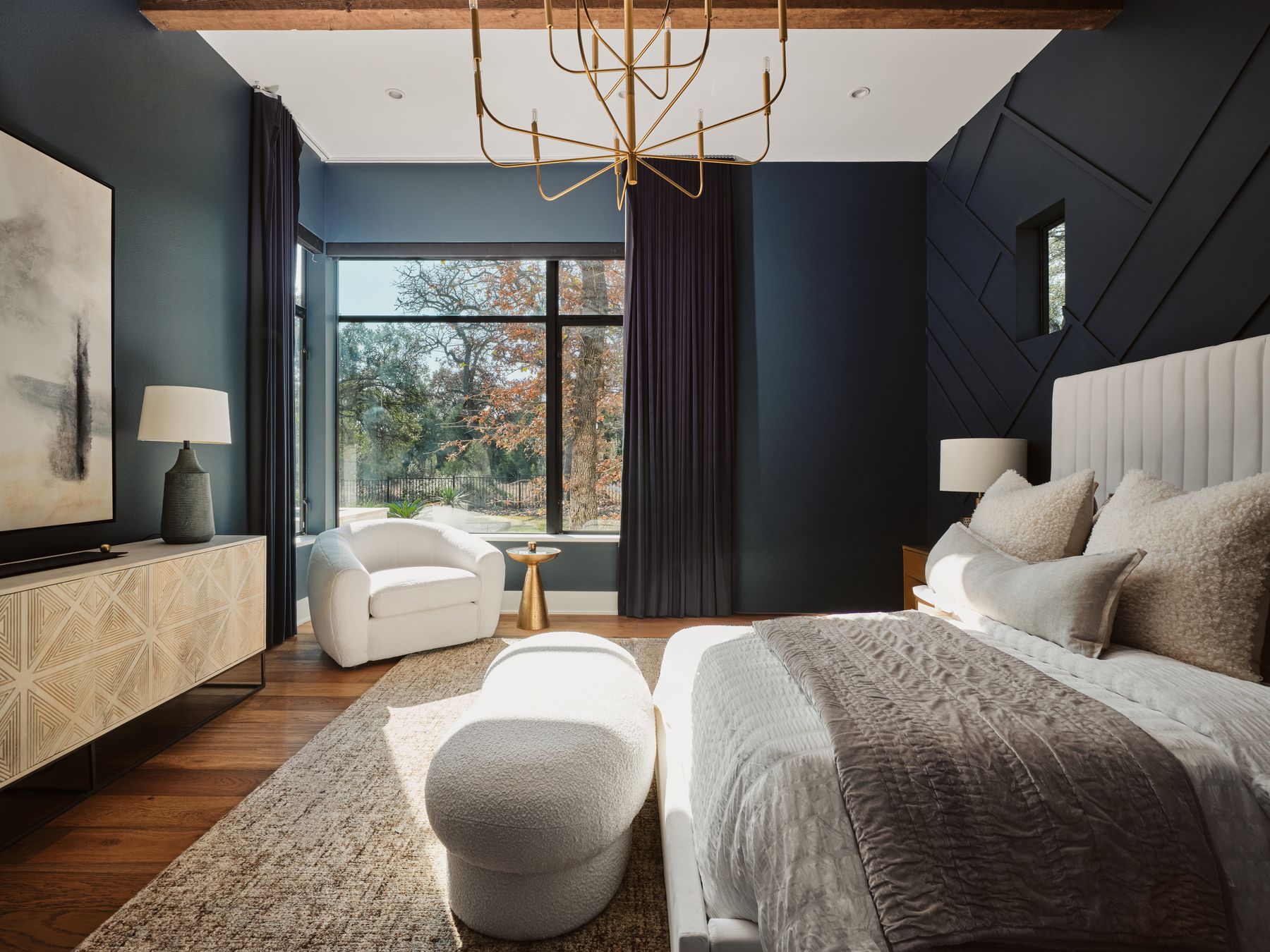 183 Tiffanie Way Austin, TX 78737 - Photo 16 of 37 Bedroom featuring wood finished floors, hanging lights, and an accent wall