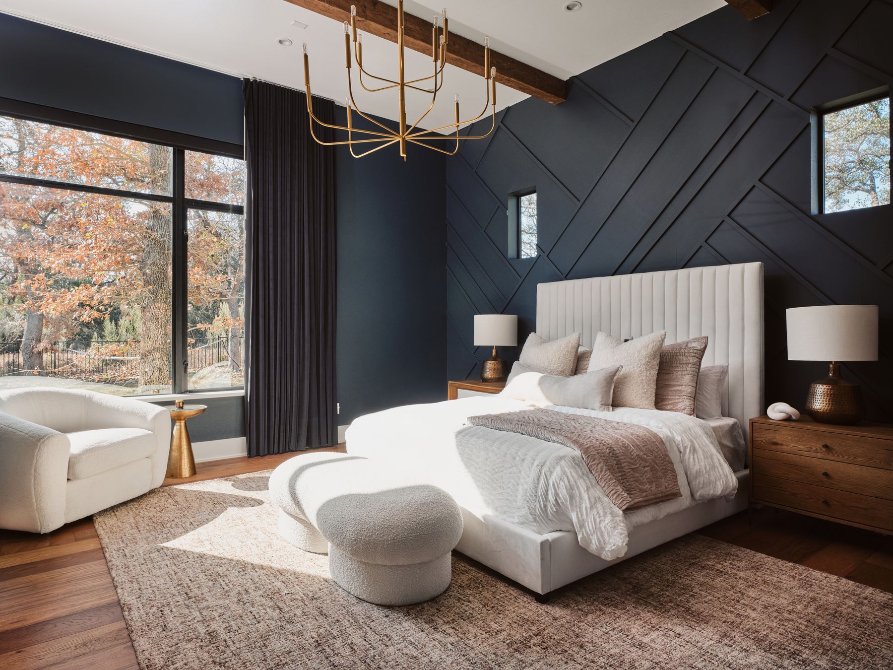 183 Tiffanie Way Austin, TX 78737 - Photo 17 of 37 Bedroom with beamed ceiling, wood finished floors, an accent wall, suspended lighting, and a decorative wall