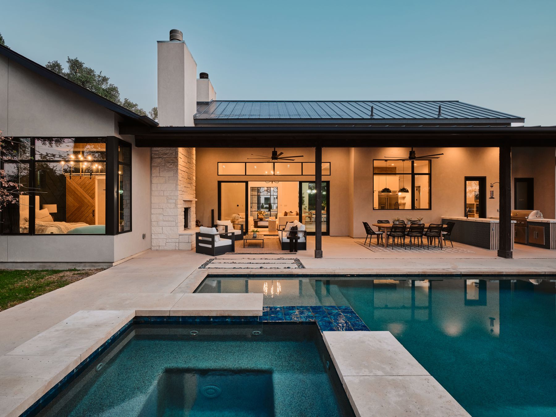 183 Tiffanie Way Austin, TX 78737 - Photo 2 of 37 Back of property with an outdoor living / dining area, stone siding, a patio, stucco siding, and area for grilling