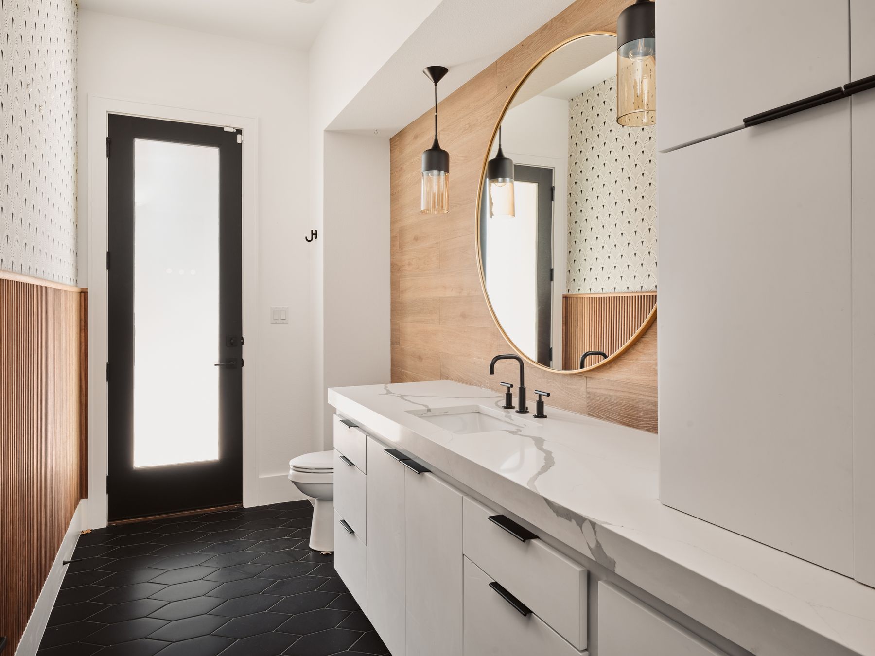183 Tiffanie Way Austin, TX 78737 - Photo 25 of 37 Half bath with vanity, wooden walls, and dark tile patterned floors
