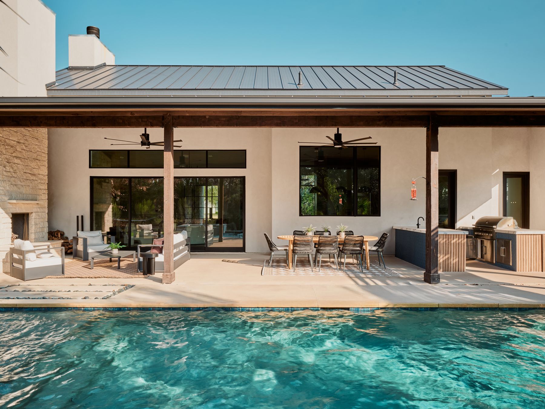 183 Tiffanie Way Austin, TX 78737 - Photo 30 of 37 Rear view of house featuring area for grilling, an outdoor pool, stucco siding, an outdoor living / dining area, and a patio area