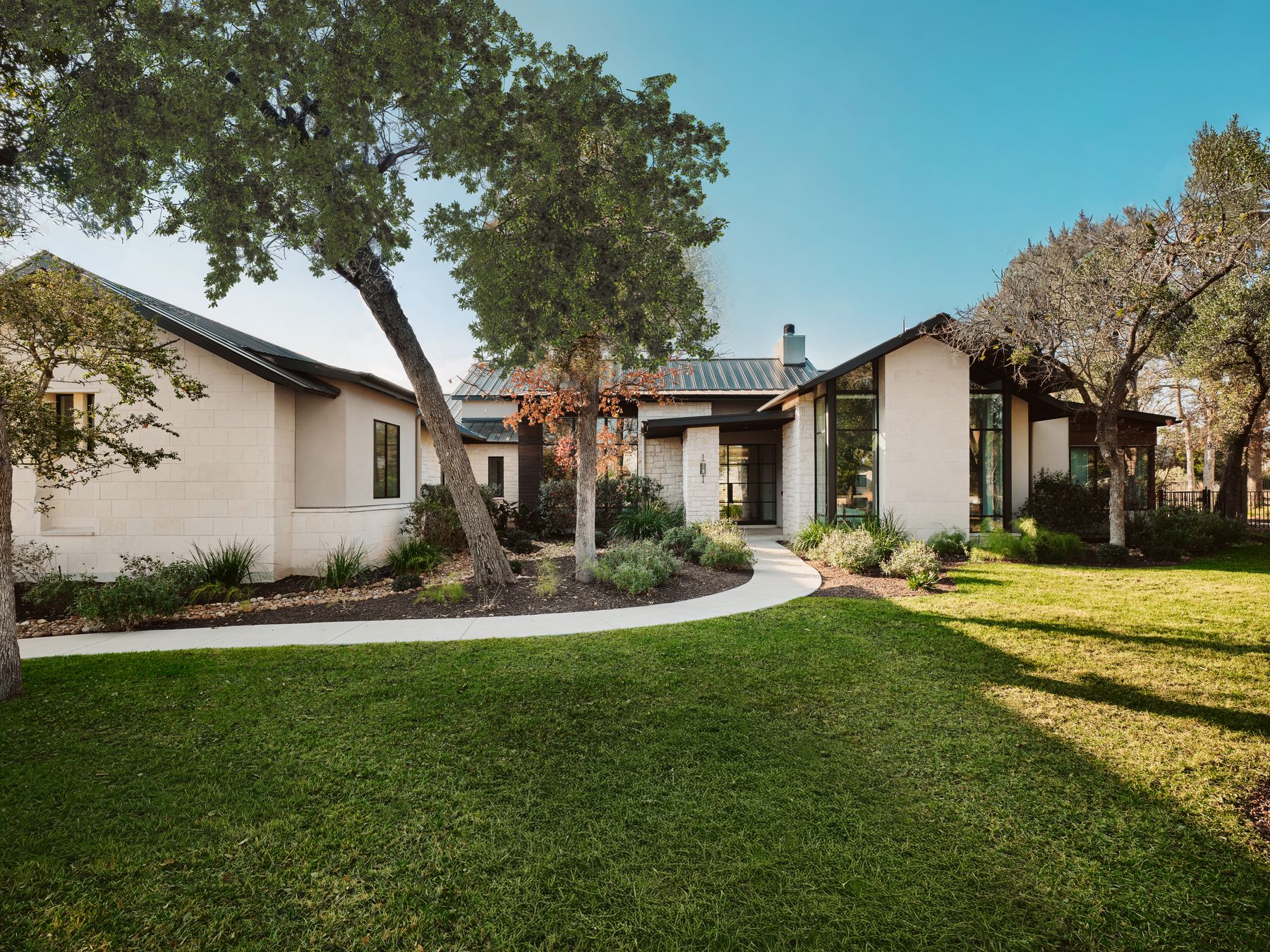 183 Tiffanie Way Austin, TX 78737 - Photo 3 of 37 View of front of property with concrete block siding, a front lawn, a chimney, and a metal roof