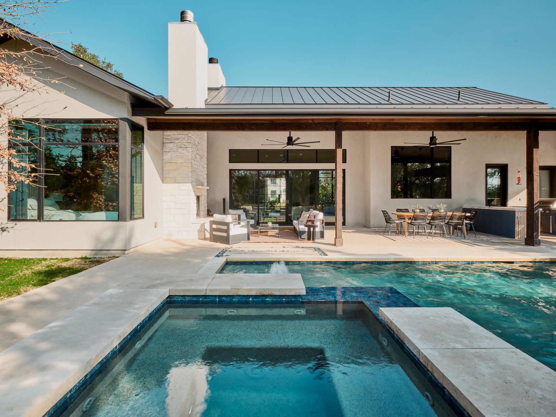 183 Tiffanie Way Austin, TX 78737 - Photo 35 of 37 Rear view of property with a chimney, a standing seam roof, a patio, and stucco siding