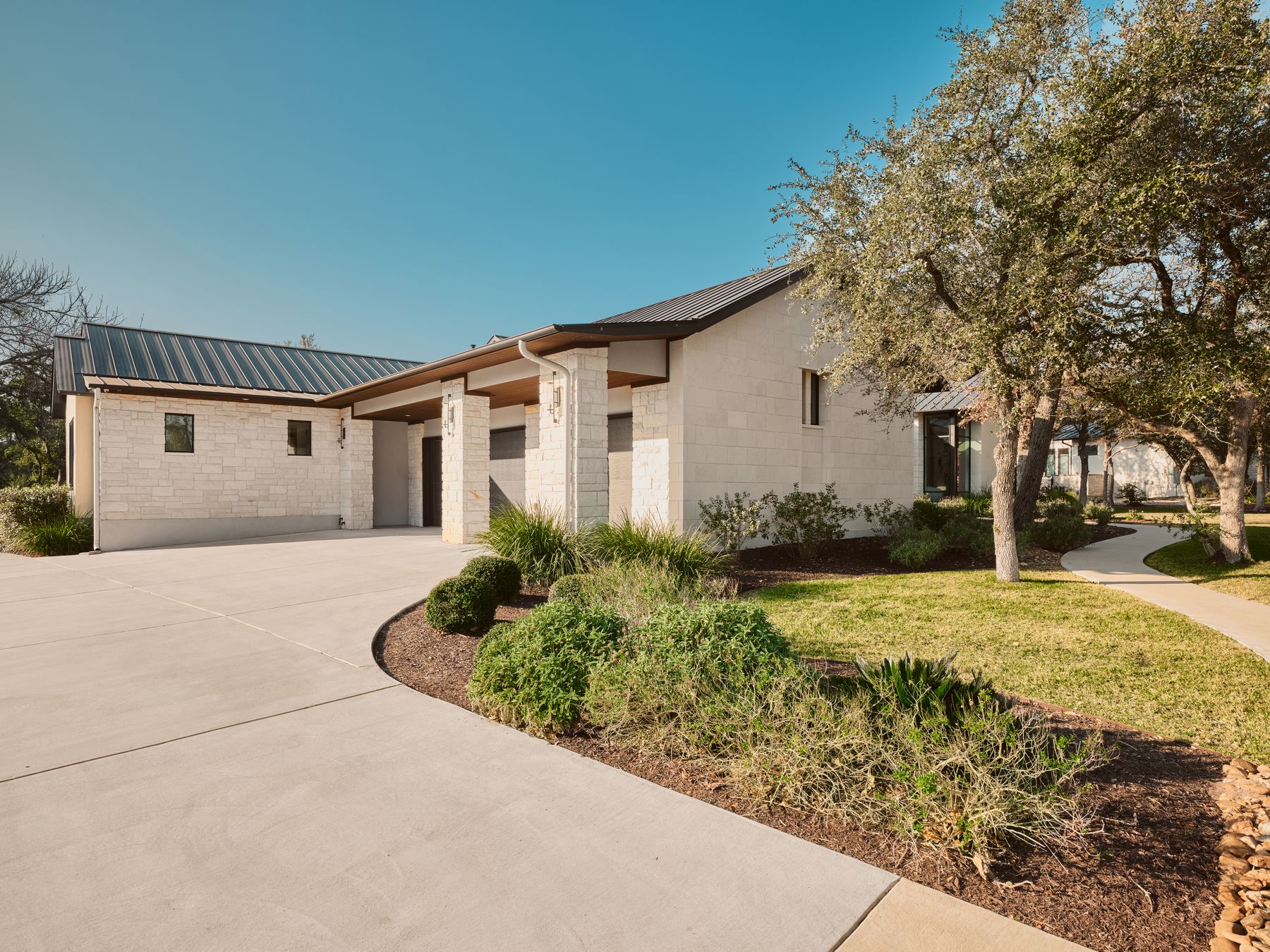 183 Tiffanie Way Austin, TX 78737 - Photo 37 of 37 View of front of house featuring a metal roof, concrete block siding, driveway, and a front lawn