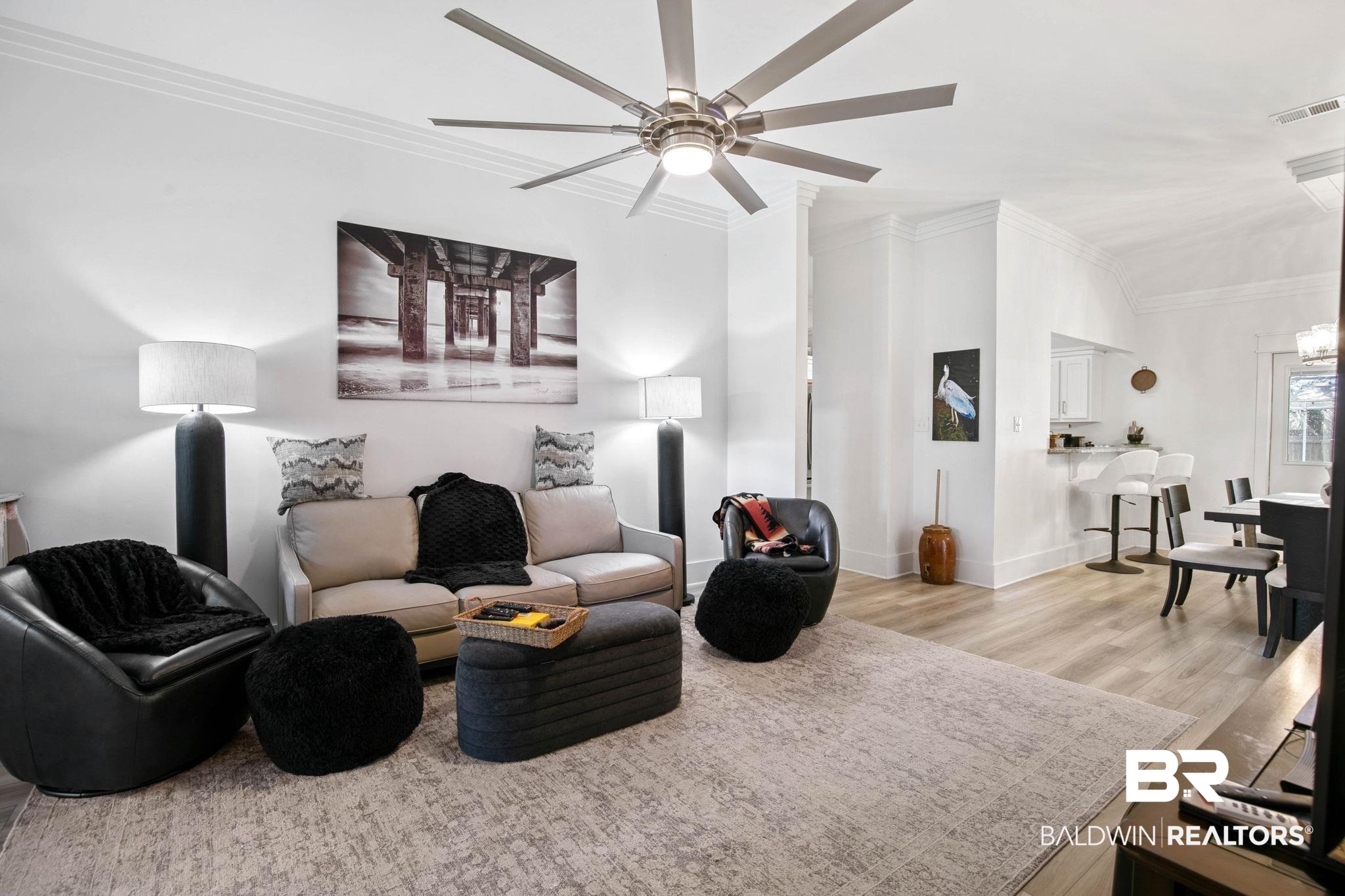 520 Juniper Place Drive Foley, AL 36535 - Photo 6 of 35 Open-concept living space featuring wood-finish flooring, a contemporary ceiling fan, recessed lighting, custom TRIPLE crown molding, and a kitchen pass-through with bar seating