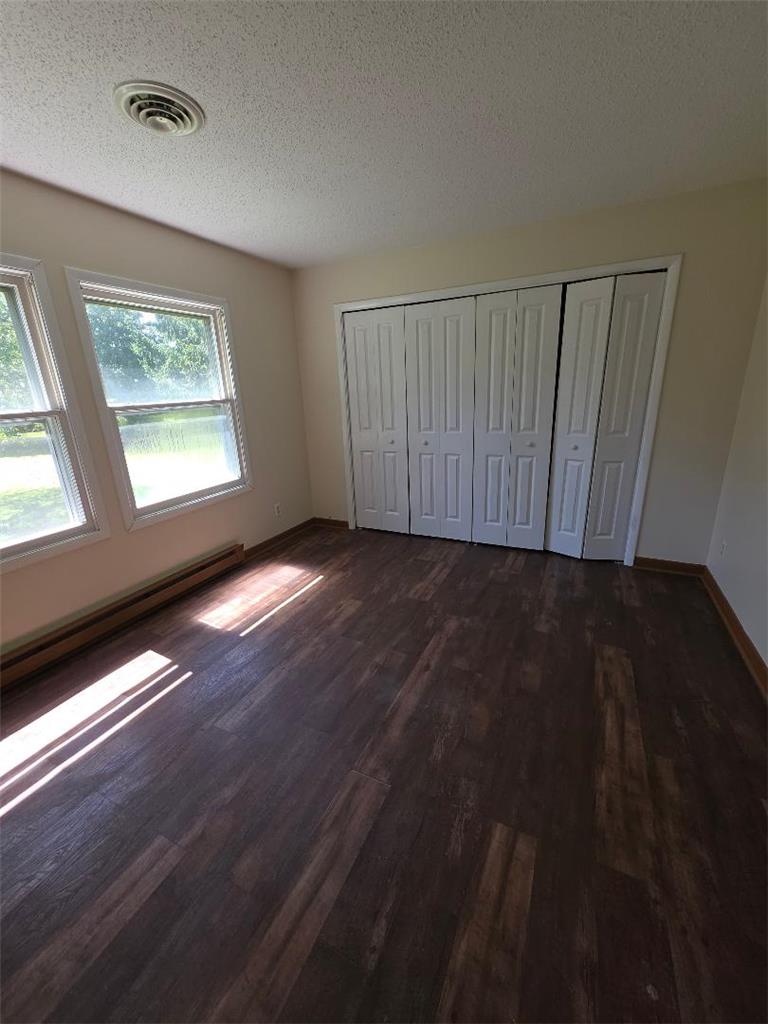 1495 Koch Road Kunkletown, PA 18058 - Photo 9 of 10 Rich wood plank flooring accents this classic bedroom featuring wide closet doors and natural lighting.
