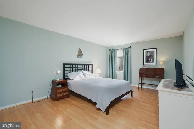 a bedroom with a bed and a tv on table