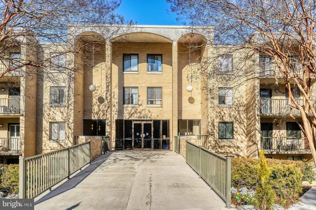 a view of a brick house with large windows