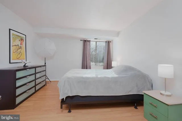 a bedroom with a bed and a night stand