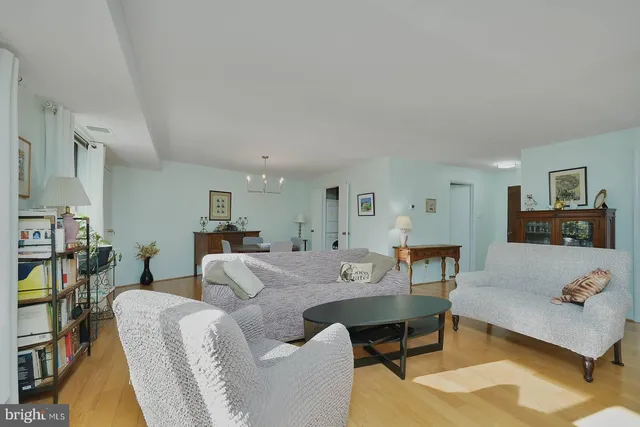 a living room with furniture a rug and a table